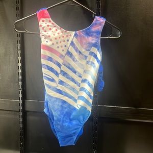 Brand new leotard with tags and hair band.  Size child x large (12-14)